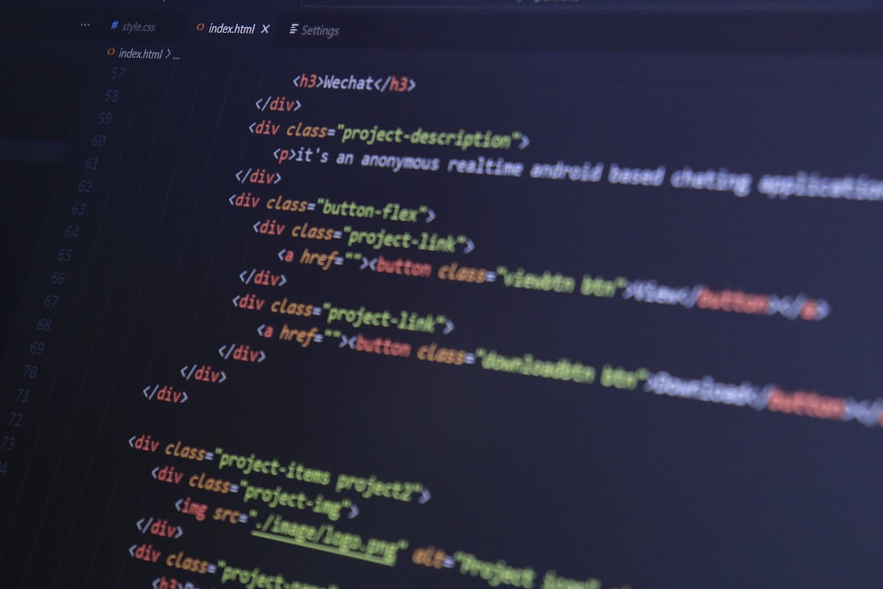 journey Close-up of HTML code with syntax highlighting on a computer monitor.